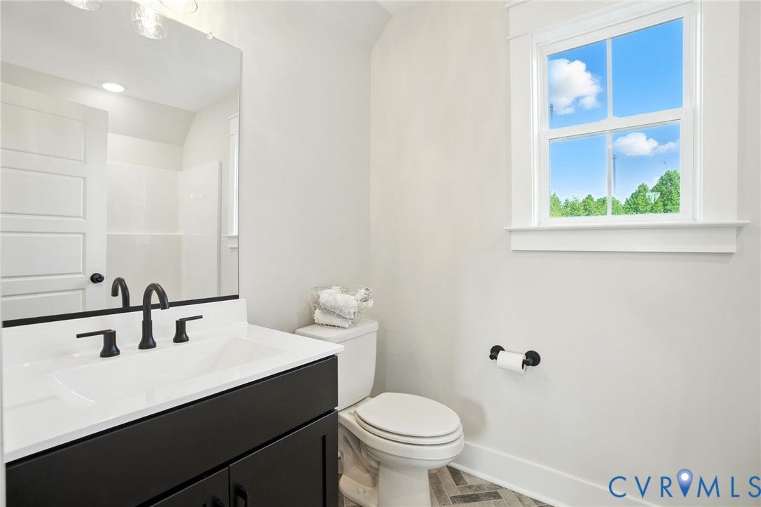 Lot 1 Needlewood Court, Olivet Church Estates, New Kent, VA 23124 White vanity with a rectangular undermount sink, matte black faucet, and clear mirror