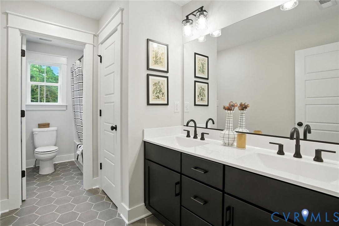 Lot 1 Needlewood Court, Olivet Church Estates, New Kent, VA 23124 Dual vanity with matte black fixtures, white countertops, and dark cabinetry