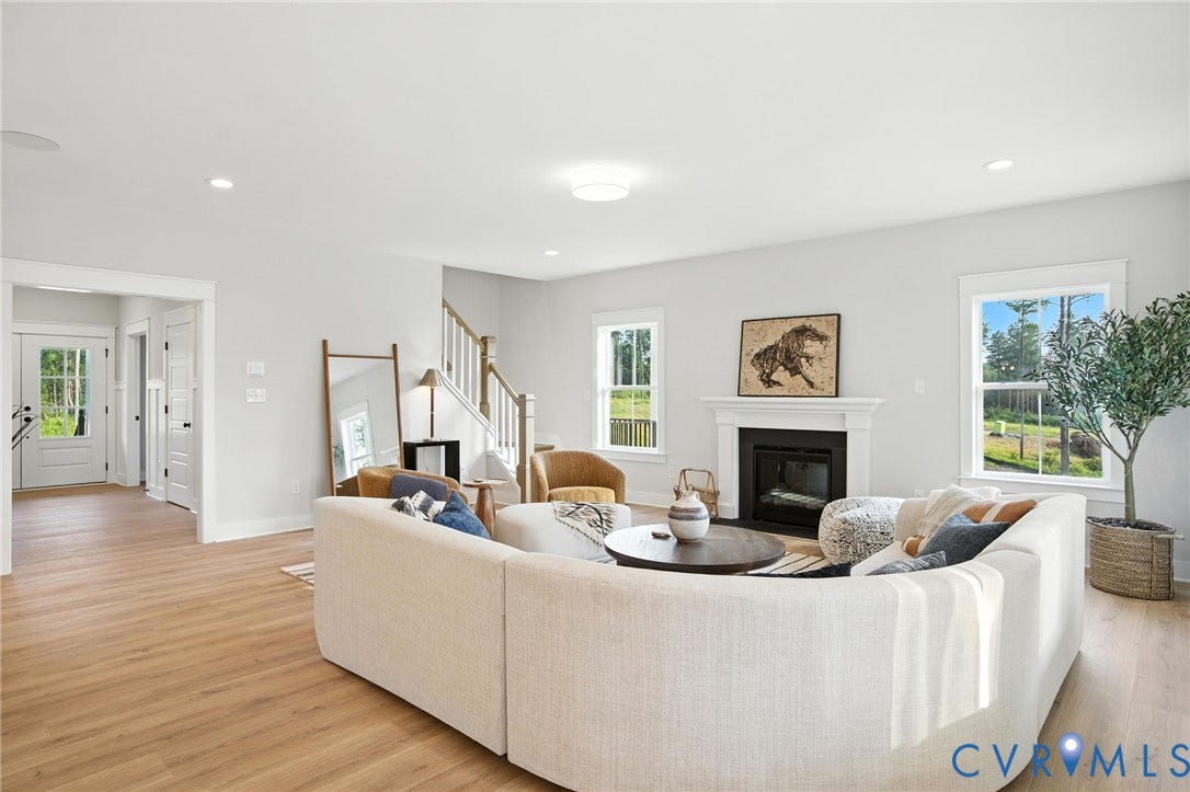 Lot 1 Needlewood Court, Olivet Church Estates, New Kent, VA 23124 Hardwood-finish flooring, recessed lighting, white trim, a fireplace with a mantel, and a staircase with a wooden handrail