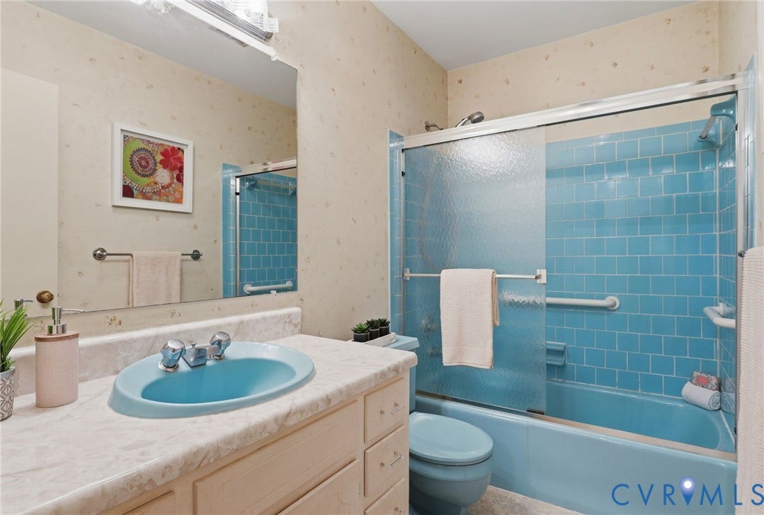 4810 Conduit Road, Colonial Heights, VA 23834 Bathroom featuring a vanity with a drop-in sink, a built-in tub with a tiled surround, and a sliding glass shower enclosure