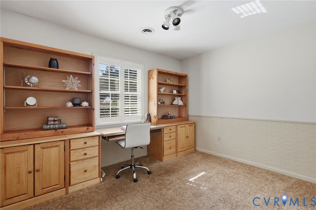 4810 Conduit Road, Colonial Heights, VA 23834 Built-in cabinetry with shelving, desk area, window with plantation shutters, overhead track lighting, and wainscoting detail