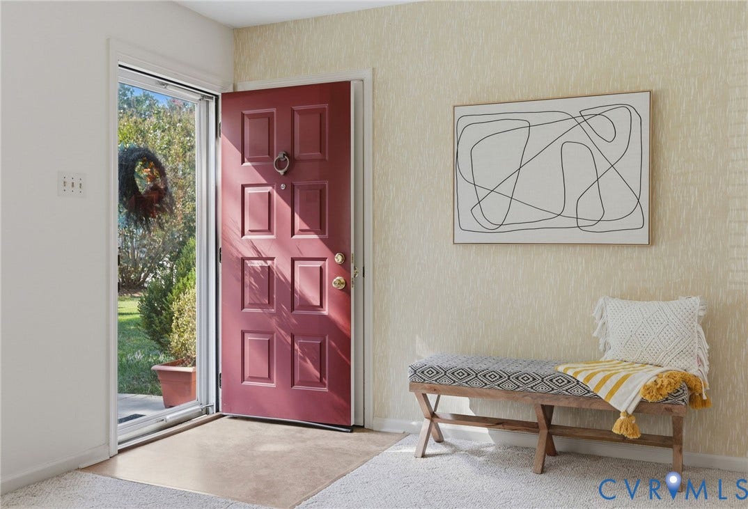 4810 Conduit Road, Colonial Heights, VA 23834 Entryway featuring a paneled door, textured wall covering, and light-toned carpeting
