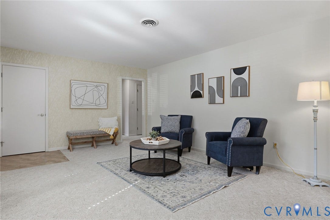 4810 Conduit Road, Colonial Heights, VA 23834 Light-colored carpeting with an area rug, white walls, and a textured accent wall
