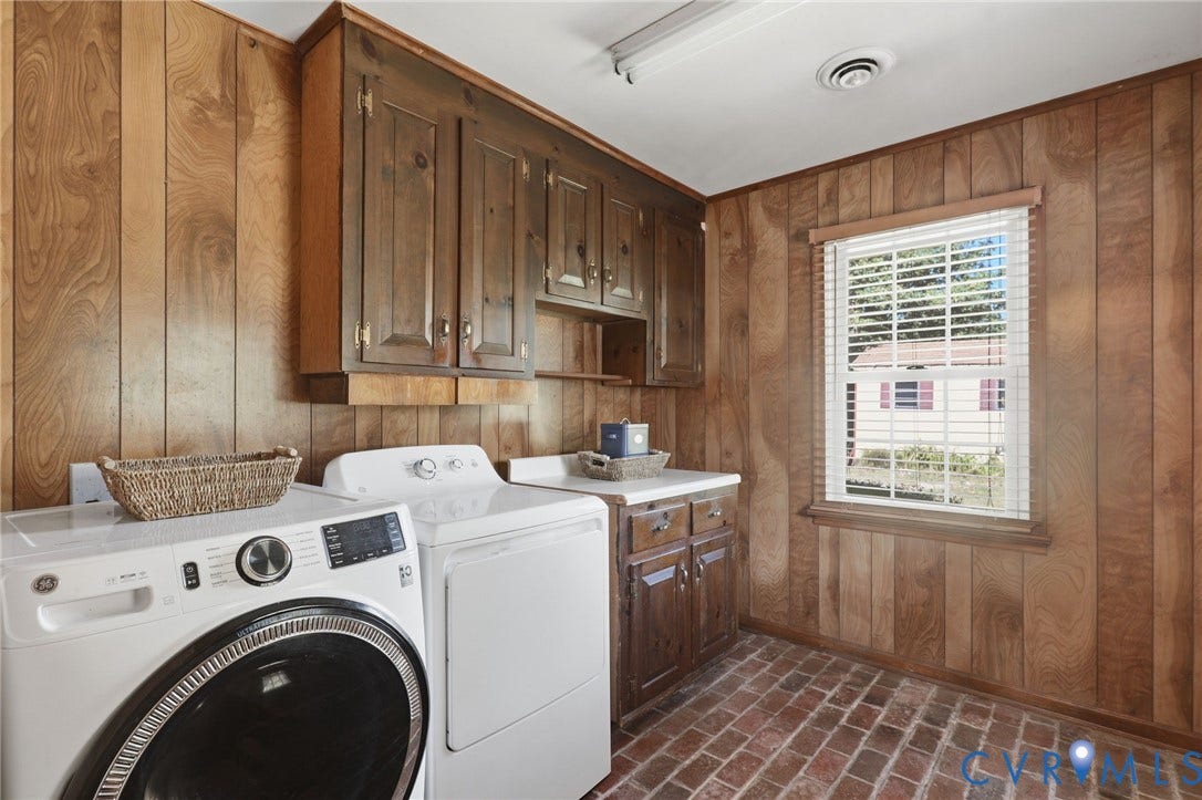 4810 Conduit Road, Colonial Heights, VA 23834 Wood-paneled room with brick flooring, featuring a single window with blinds, upper storage cabinetry, and lower storage cabinetry with a countertop