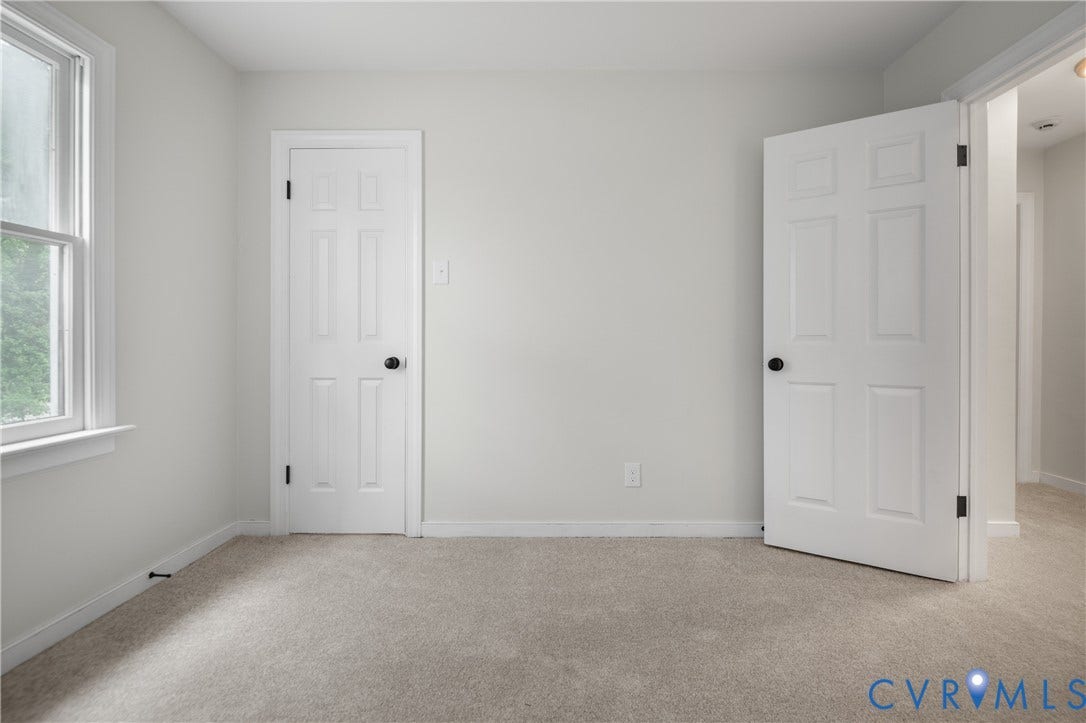 4525 Old Mesa Drive, North Chesterfield, VA 23237 Light-colored walls, neutral carpeting, white trim, and a white paneled door with black hardware