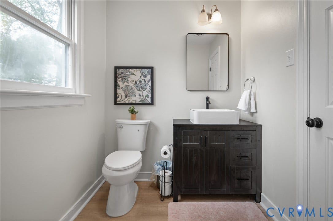 4525 Old Mesa Drive, North Chesterfield, VA 23237 Dark wood-finish vanity with a rectangular vessel sink, wall-mounted faucet, and rectangular mirror