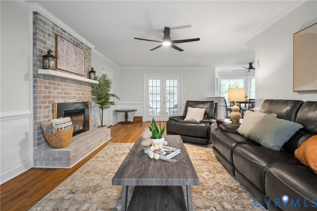 4525 Old Mesa Drive, North Chesterfield, VA 23237 Hardwood-style flooring, brick fireplace with mantel, French patio doors, crown molding, and ceiling fan with integrated lighting