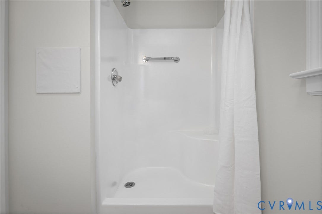 4525 Old Mesa Drive, North Chesterfield, VA 23237 Integrated shower and tub unit featuring a built-in seat and grab bar