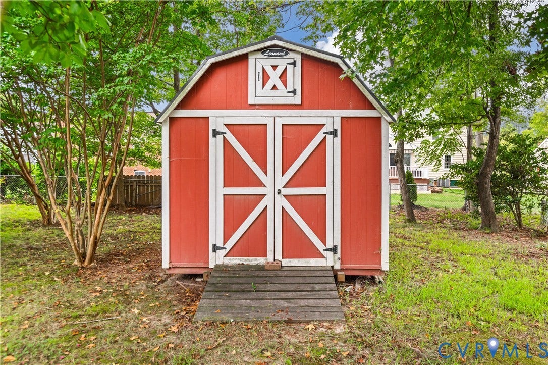 4525 Old Mesa Drive, North Chesterfield, VA 23237 Red storage shed with white trim and a gable roof