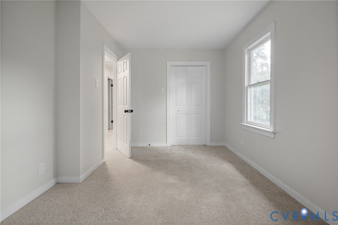 4525 Old Mesa Drive, North Chesterfield, VA 23237 Neutral tone wall paint, light-colored carpet, white trim, and a window with natural light