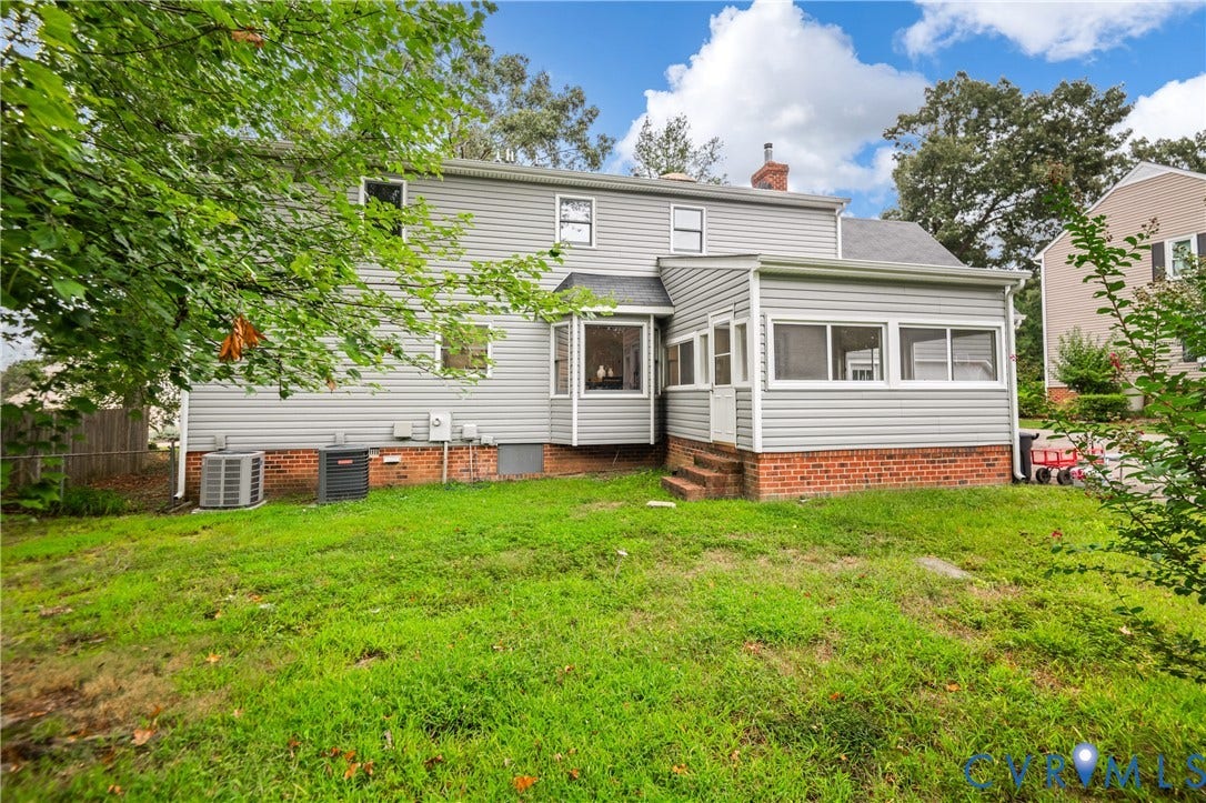 4525 Old Mesa Drive, North Chesterfield, VA 23237 Expansive backyard featuring a screened-in porch with brick foundation, bay window, and a second-story window