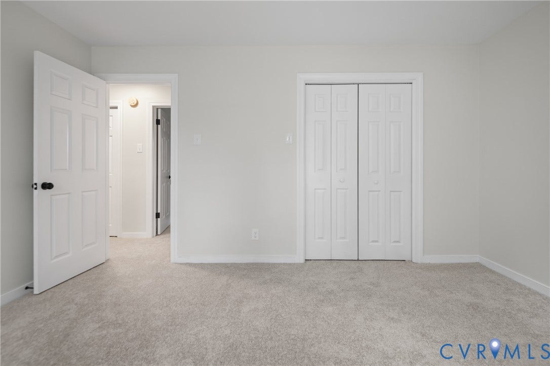 4525 Old Mesa Drive, North Chesterfield, VA 23237 Plush carpet flooring, white interior doors with black hardware, and bi-fold closet doors