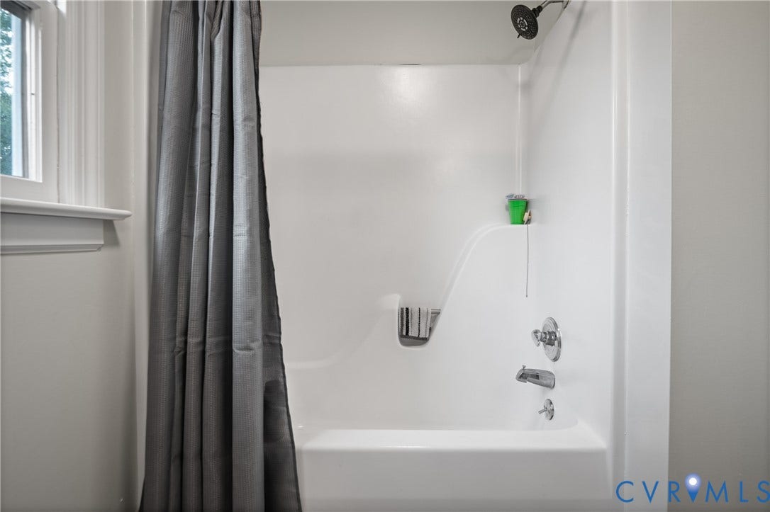 4525 Old Mesa Drive, North Chesterfield, VA 23237 White acrylic tub and shower combination with chrome fixtures and an integrated soap dish