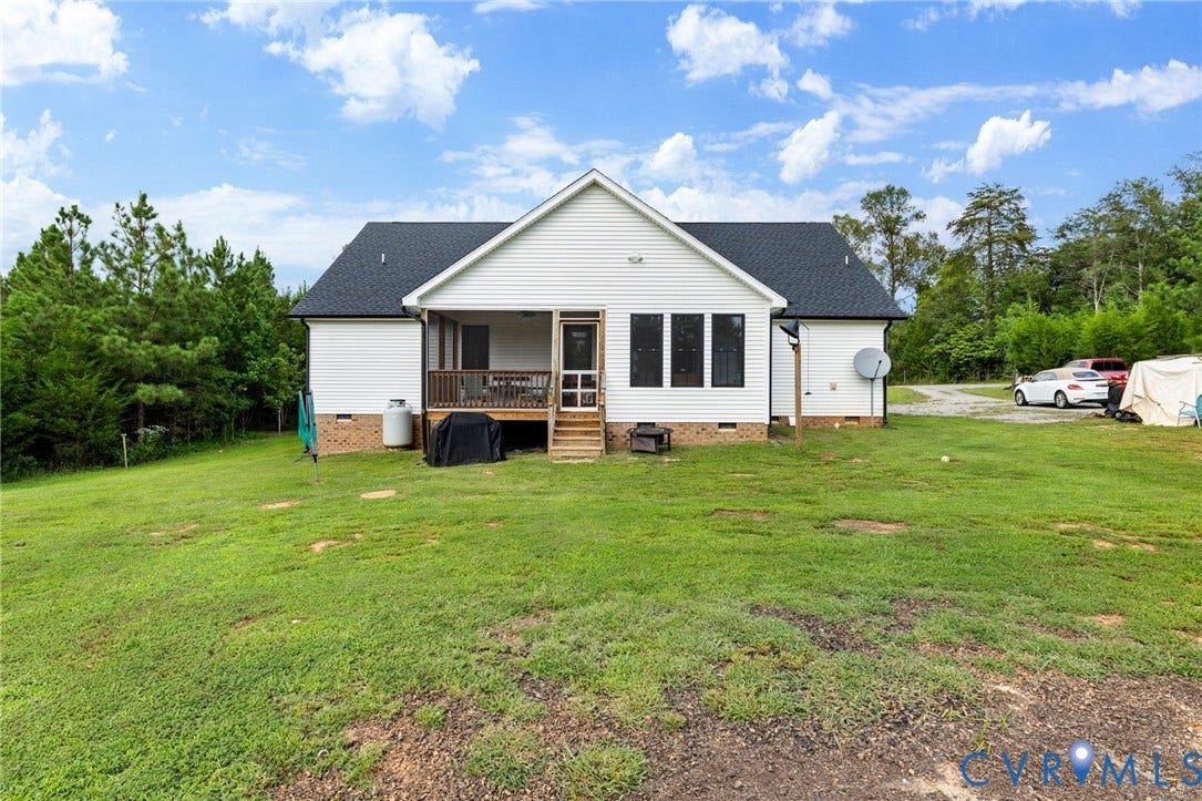 2927 Poorhouse Road, 522 Corridor, Goochland, VA 23063 White siding exterior, dark shingle roof, screened porch, wood deck, and a multi-pane window