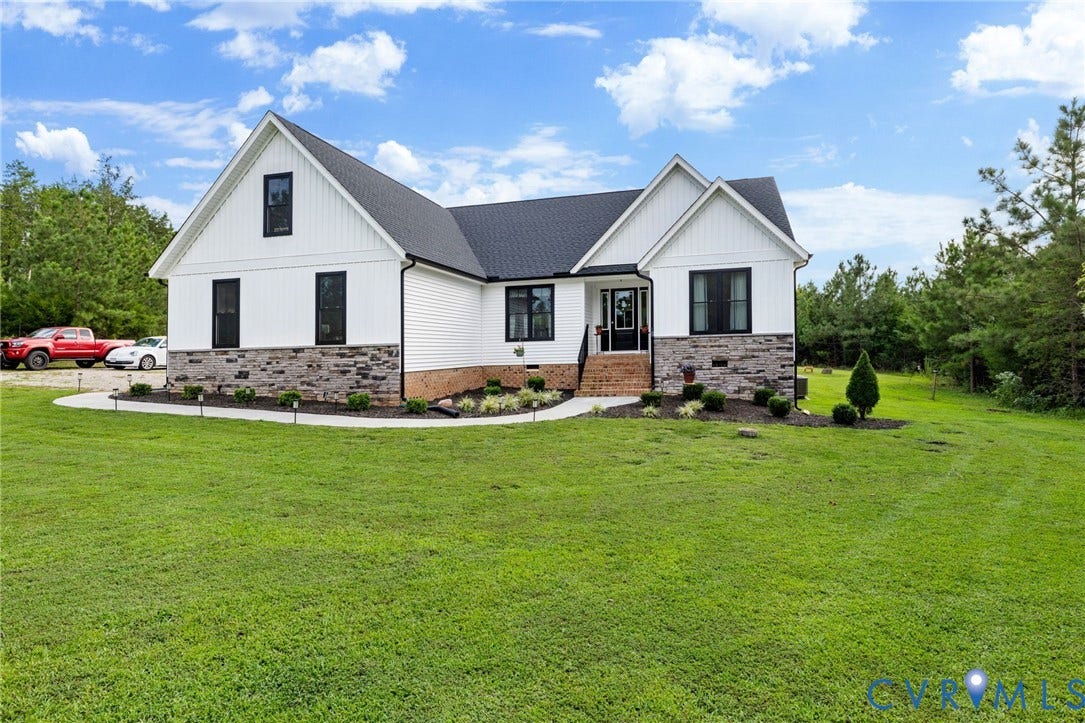 2927 Poorhouse Road, 522 Corridor, Goochland, VA 23063 White board and batten siding, stone facade accents, dark framed windows, dark shingle roof, and a concrete walkway