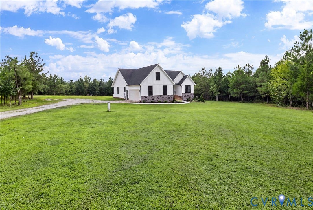 2927 Poorhouse Road, 522 Corridor, Goochland, VA 23063 White siding exterior with a dark shingle roof, stone accent facade, and a gravel driveway