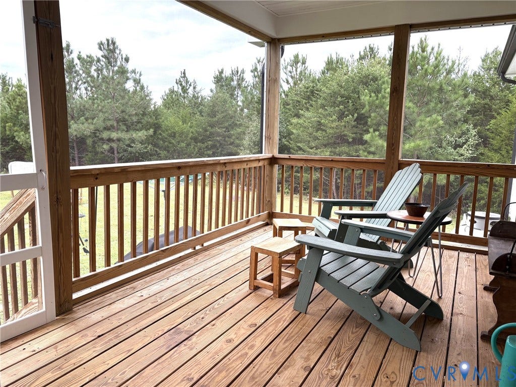 2927 Poorhouse Road, 522 Corridor, Goochland, VA 23063 Screened-in porch featuring a wooden deck, wood-finish railings, and a solid wood entry door