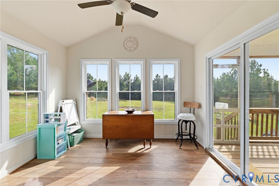2927 Poorhouse Road, 522 Corridor, Goochland, VA 23063 Vaulted ceiling with a ceiling fan, multiple windows with white trim, LVP flooring, and a sliding glass door to a deck with wood railings