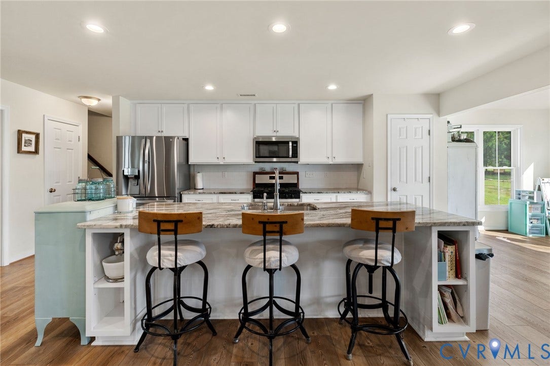 2927 Poorhouse Road, 522 Corridor, Goochland, VA 23063 Kitchen featuring white cabinetry, stainless steel appliances, an island with countertop seating, recessed lighting, and LVP flooring
