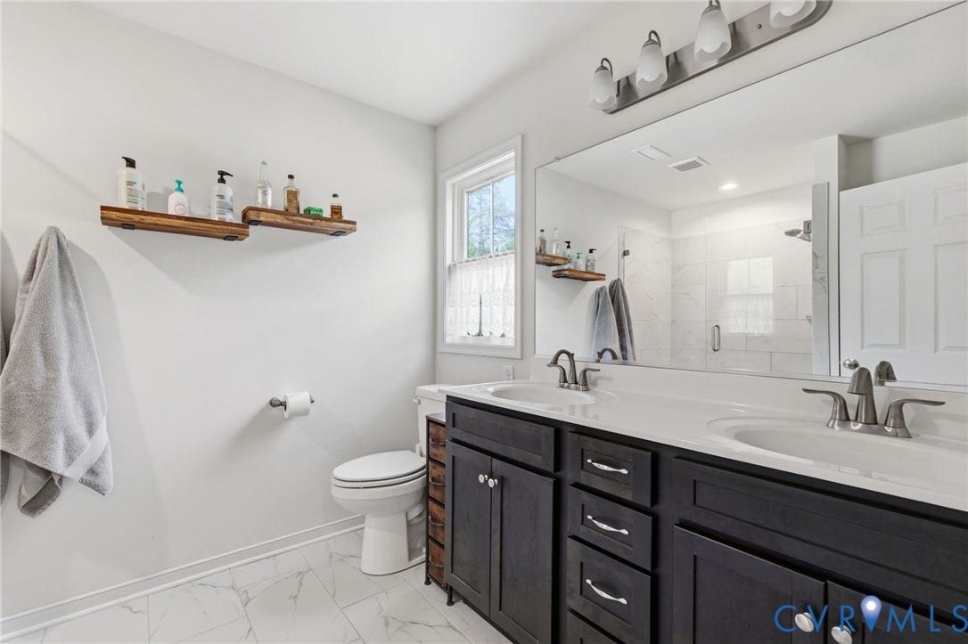 2927 Poorhouse Road, 522 Corridor, Goochland, VA 23063 Dual sink vanity with dark wood-finish cabinetry and white countertop
