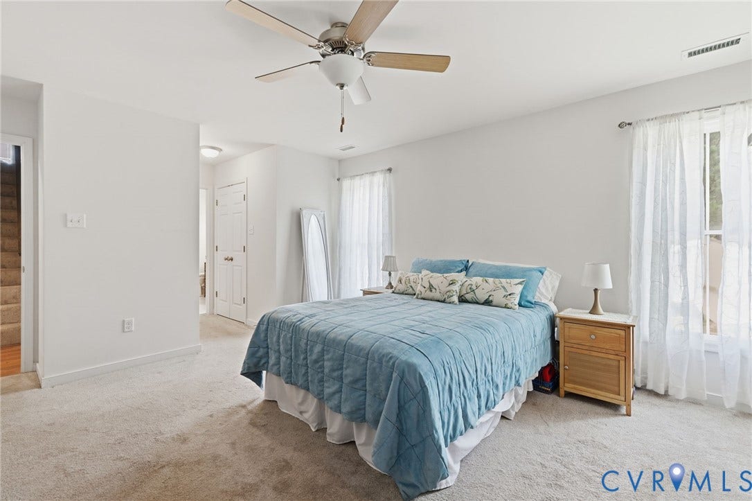 2927 Poorhouse Road, 522 Corridor, Goochland, VA 23063 Carpeted flooring, ceiling fan with light fixture, multiple windows, and a doorway