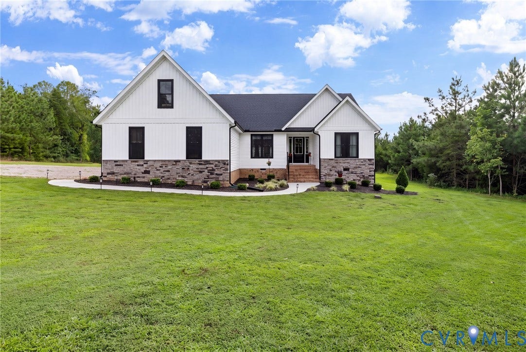 2927 Poorhouse Road, 522 Corridor, Goochland, VA 23063 Modern farmhouse exterior featuring white siding, dark trim windows, a dark roof, stone accenting, and a concrete walkway with integrated lighting