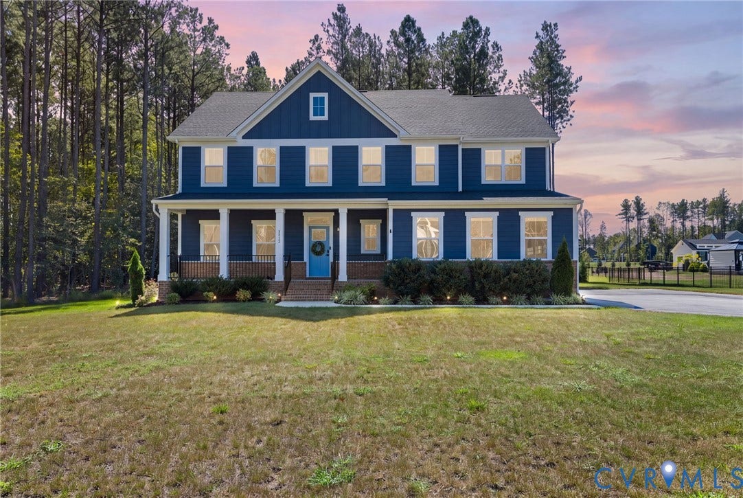 8618 McKibben Drive, The Highlands, Chesterfield, VA 23838 Two-story residence featuring a deep blue exterior, white-trimmed windows, a columned front porch, and a light blue front door