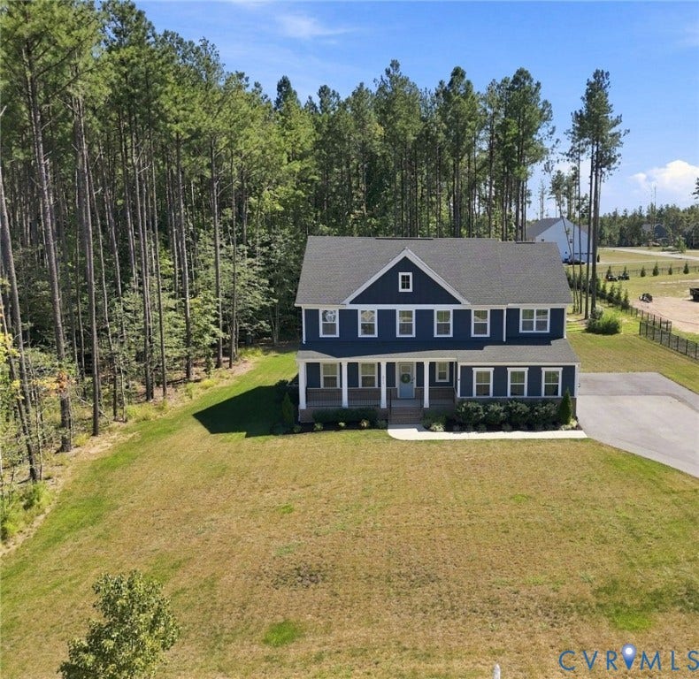 8618 McKibben Drive, The Highlands, Chesterfield, VA 23838 Traditional two-story residence featuring a deep blue exterior with white trim, a covered front porch, and a dark shingled roof