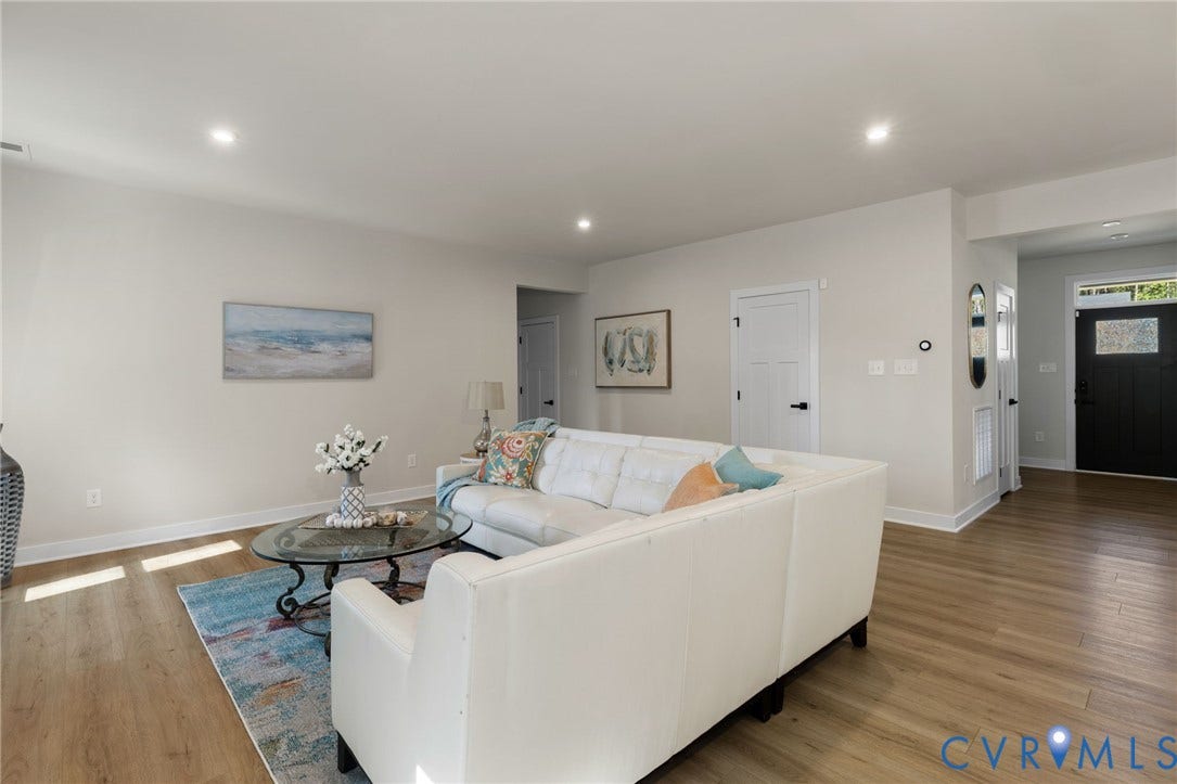 8618 McKibben Drive, The Highlands, Chesterfield, VA 23838 Recessed lighting illuminates the open living space featuring wood-finish flooring and white walls
