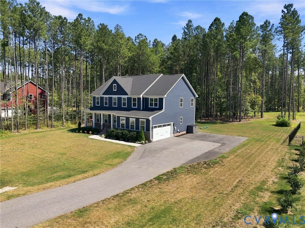 8618 McKibben Drive, The Highlands, Chesterfield, VA 23838 Two-story residence with blue siding, a covered front porch, and an attached two-car garage