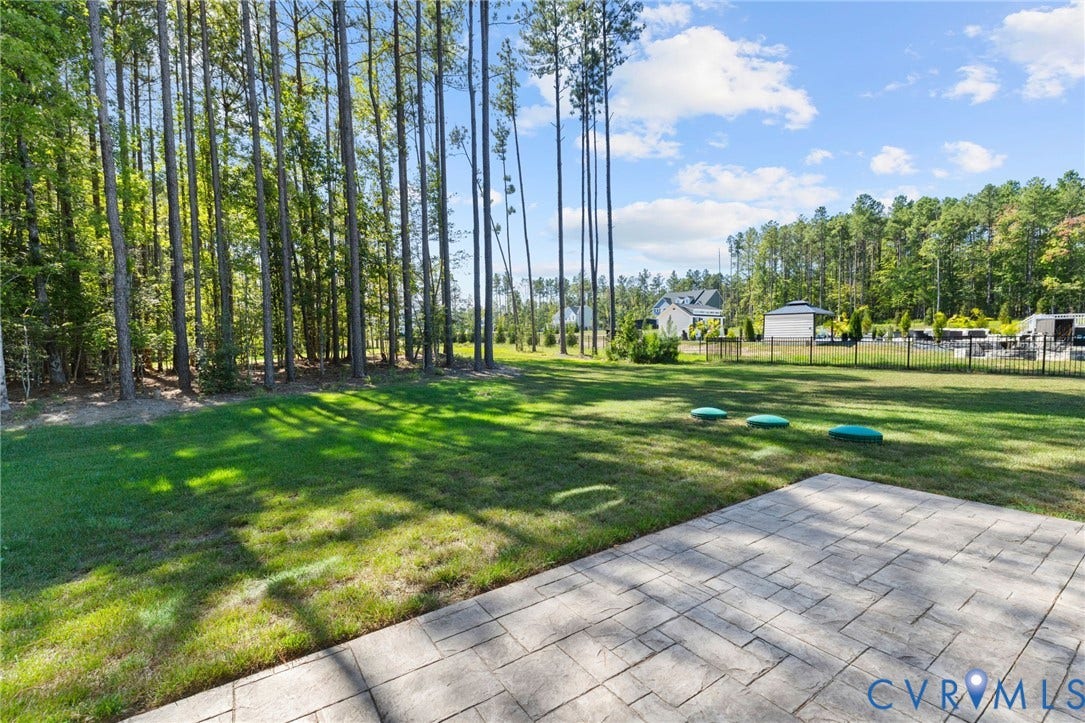 8618 McKibben Drive, The Highlands, Chesterfield, VA 23838 Expansive grassy yard with mature trees and a stamped concrete patio