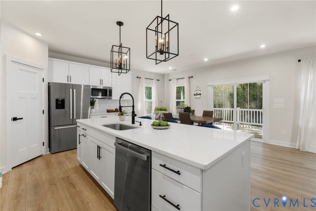 8618 McKibben Drive, The Highlands, Chesterfield, VA 23838 White shaker cabinetry, stainless steel appliances, central island with sink, wood-finish flooring, and sliding glass door