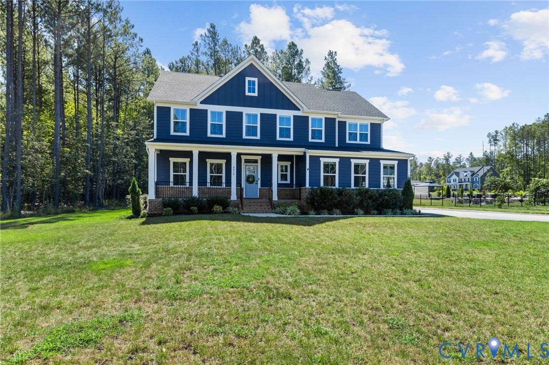 8618 McKibben Drive, The Highlands, Chesterfield, VA 23838 Two-story residence featuring a blue siding exterior, a covered front porch with white columns, a gray shingle roof, and white-framed windows