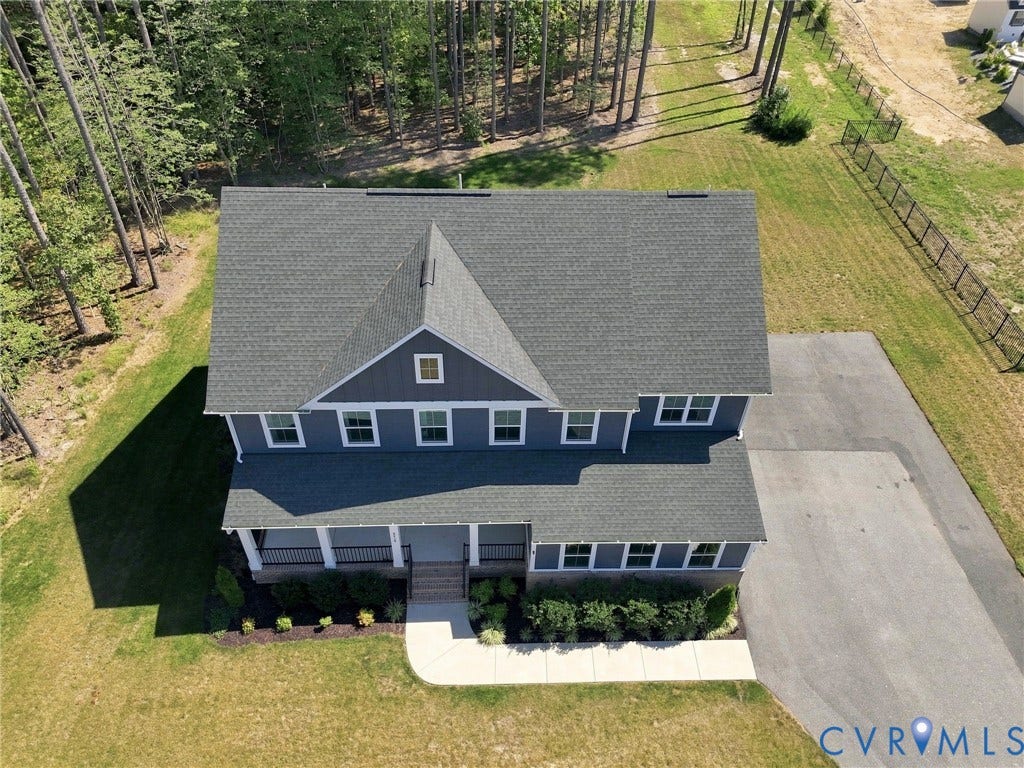 8618 McKibben Drive, The Highlands, Chesterfield, VA 23838 Two-story residence with a gray shingle roof, blue siding, a covered front porch, and a paved driveway