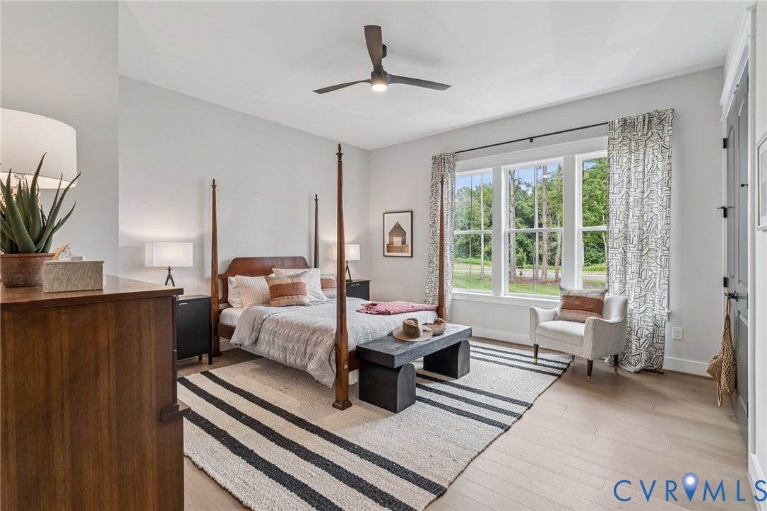 Lot 2 Needlewood Court, Olivet Church Estates, New Kent, VA 23124 Vaulted ceiling with a ceiling fan, light wood-finish flooring, white walls, and a large window with white trim