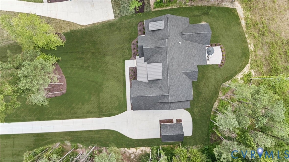 Lot 2 Needlewood Court, Olivet Church Estates, New Kent, VA 23124 Expansive lot featuring a large residence with a dark shingle roof, concrete driveway, and a detached structure