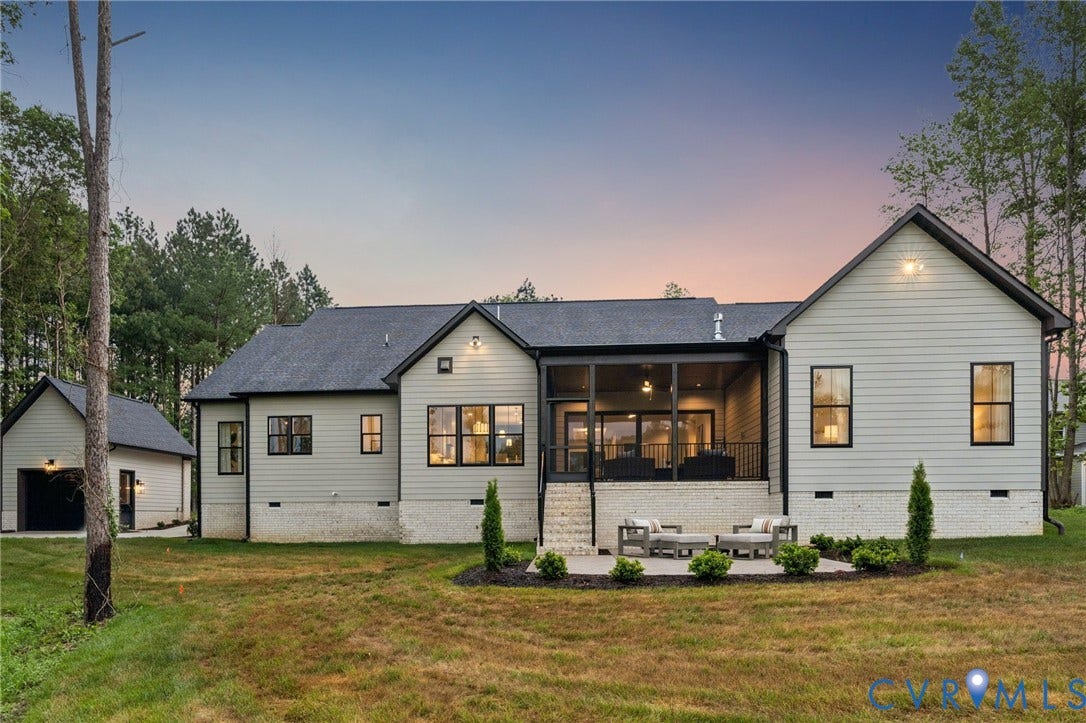 Lot 2 Needlewood Court, Olivet Church Estates, New Kent, VA 23124 Light gray horizontal siding with dark trim, screened-in porch, stone patio, detached garage, and mature trees