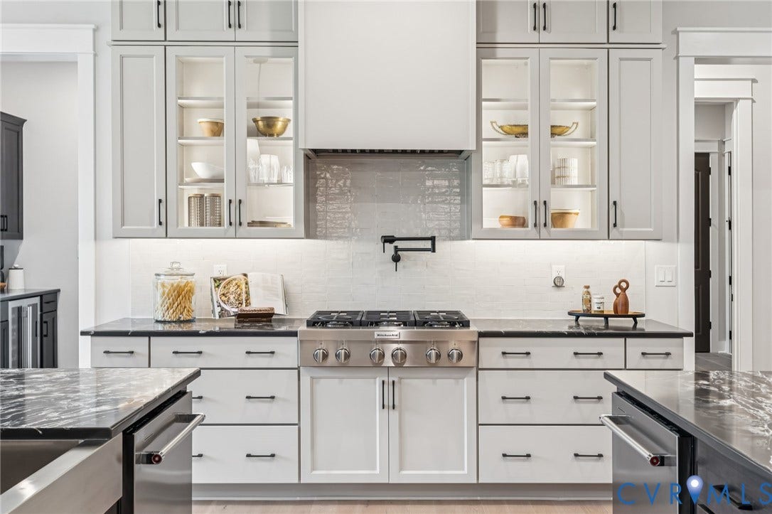 Lot 2 Needlewood Court, Olivet Church Estates, New Kent, VA 23124 Stainless steel range with pot filler, illuminated glass-front cabinetry, black stone countertops, and light gray cabinetry with dark hardware