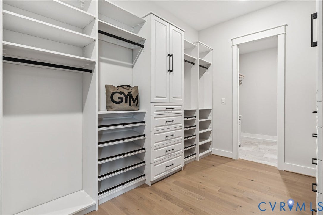 Lot 2 Needlewood Court, Olivet Church Estates, New Kent, VA 23124 Custom closet system featuring shelving, hanging rods, built-in cabinetry with drawers, and wood-finish flooring