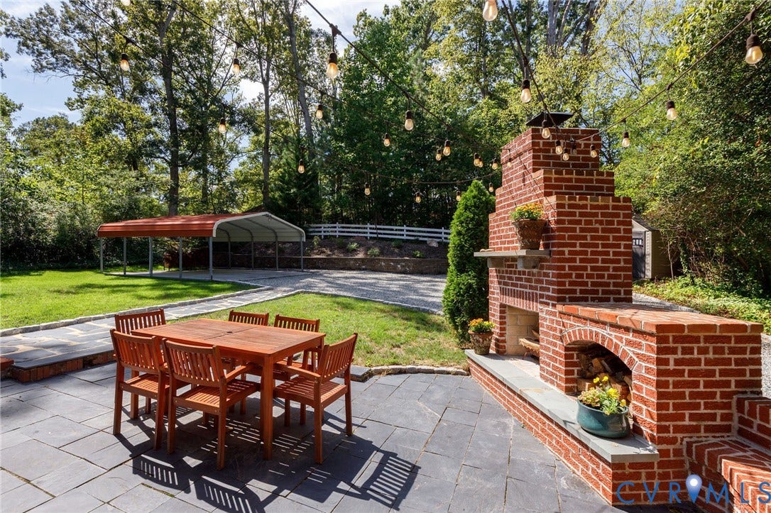 7433 Cherokee Road, Richmond, VA 23225 Outdoor fireplace, slate patio, and lawn by driveway