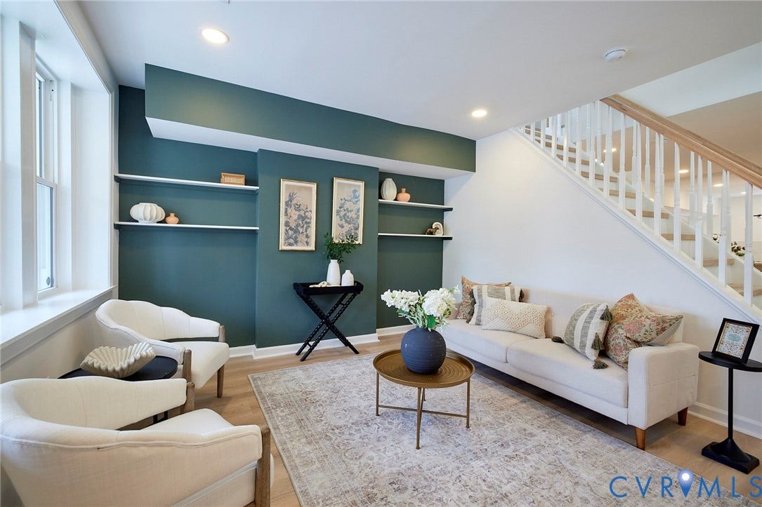 3103 Q St, Church Hill, Richmond, VA 23223 Recessed lighting illuminates the living space with built-in shelving, wood-finish flooring, and a staircase with white balusters and a wood handrail
