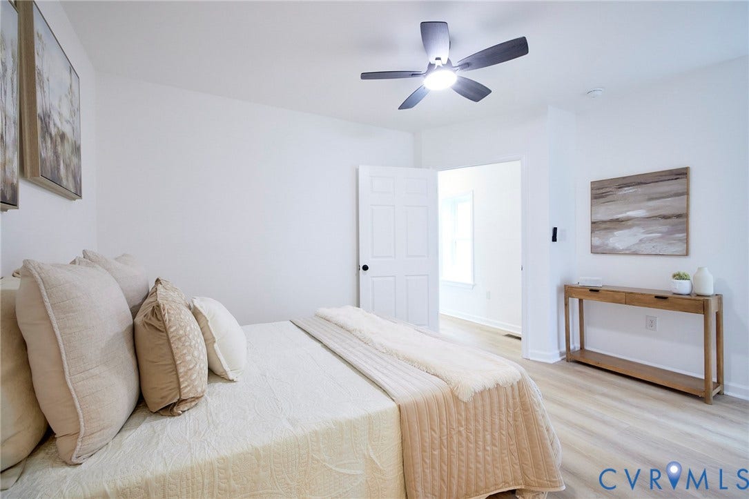 3103 Q St, Church Hill, Richmond, VA 23223 Ceiling fan with integrated lighting, wood-finish flooring, white walls, and a white interior door with black hardware