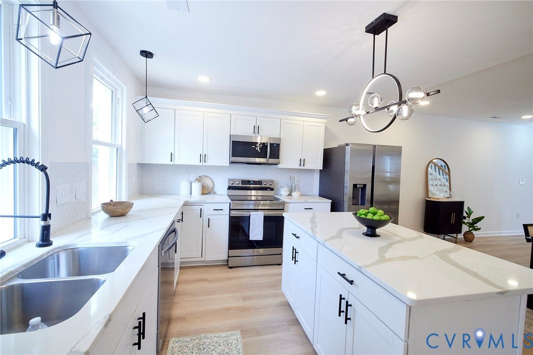 3103 Q St, Church Hill, Richmond, VA 23223 Kitchen featuring white cabinetry, stainless steel appliances, marble-look countertops, a center island, and wood-finish flooring