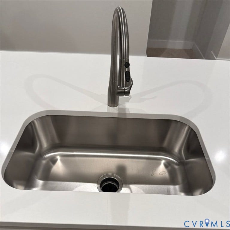 9452 belladdie Way, Glen Allen, VA 23059 Stainless steel undermount sink with a white countertop and a brushed nickel pull-down faucet
