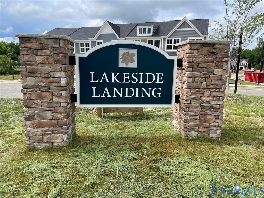 Stone veneer sign posts frame a community entrance sign
