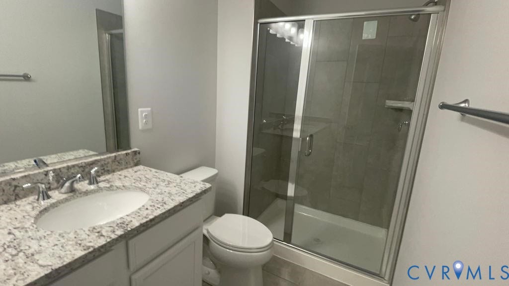 Vanity with granite-style countertop, undermount sink, and chrome faucet