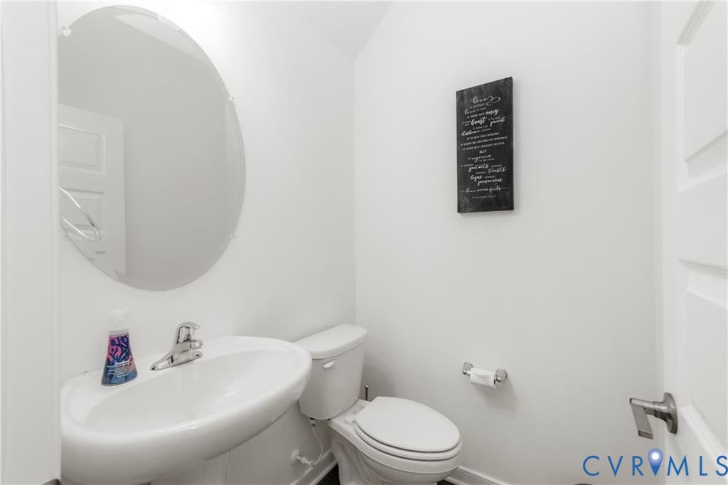 12221 Dutch Elm Circle, Midlothian, VA 23112 Pedestal sink with chrome fixtures and an oval wall-mounted mirror