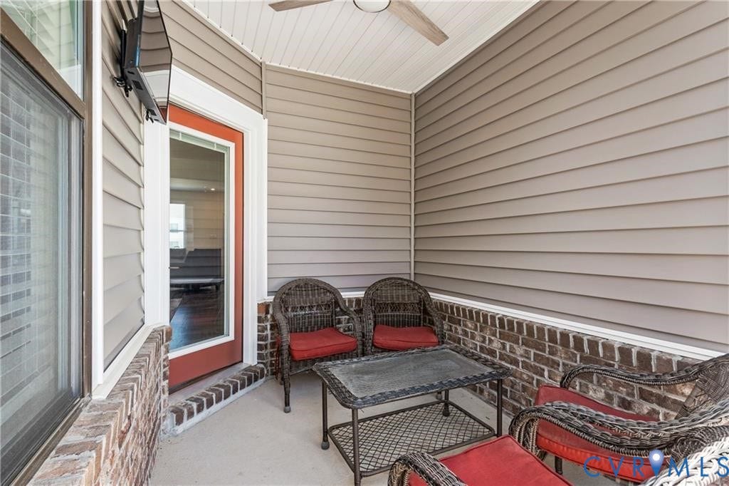 12221 Dutch Elm Circle, Midlothian, VA 23112 Covered patio featuring a ceiling fan, horizontal siding, and a brick knee wall