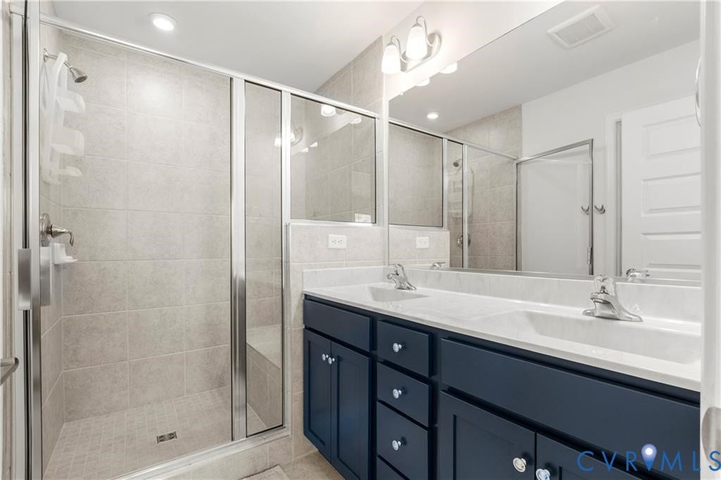 12221 Dutch Elm Circle, Midlothian, VA 23112 Dual vanity with white undermount sinks, chrome faucets, and dark cabinetry