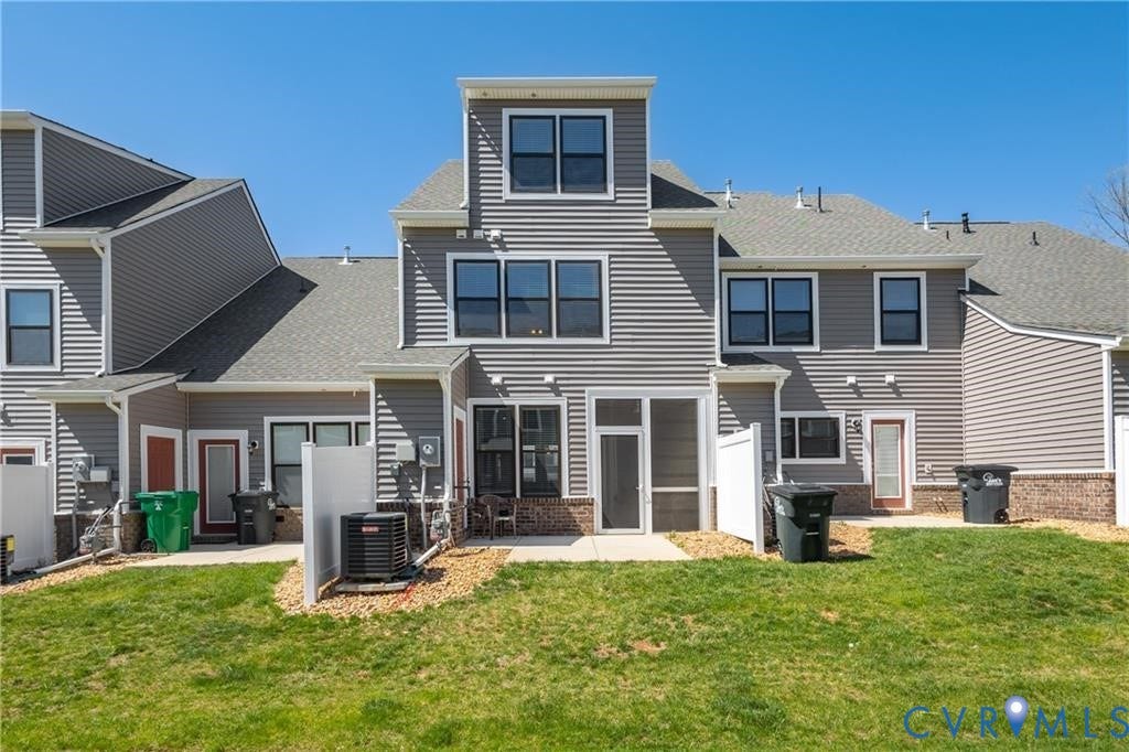 12221 Dutch Elm Circle, Midlothian, VA 23112 Gray siding exterior with white trim, multi-level design, screened porch, and a gravel-bordered patio